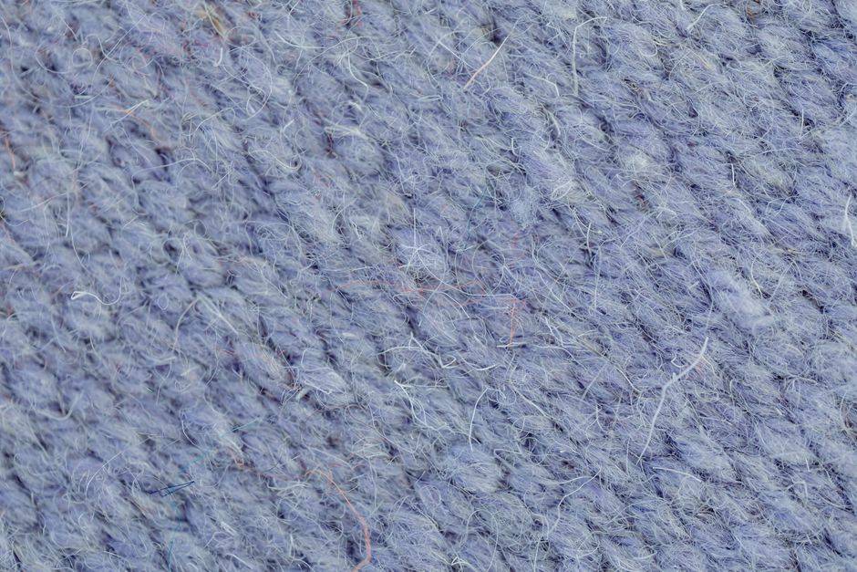 Close-up macro texture of hand-spun wool yarn