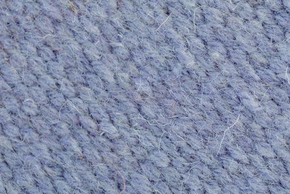 Close-up macro texture of hand-spun wool yarn